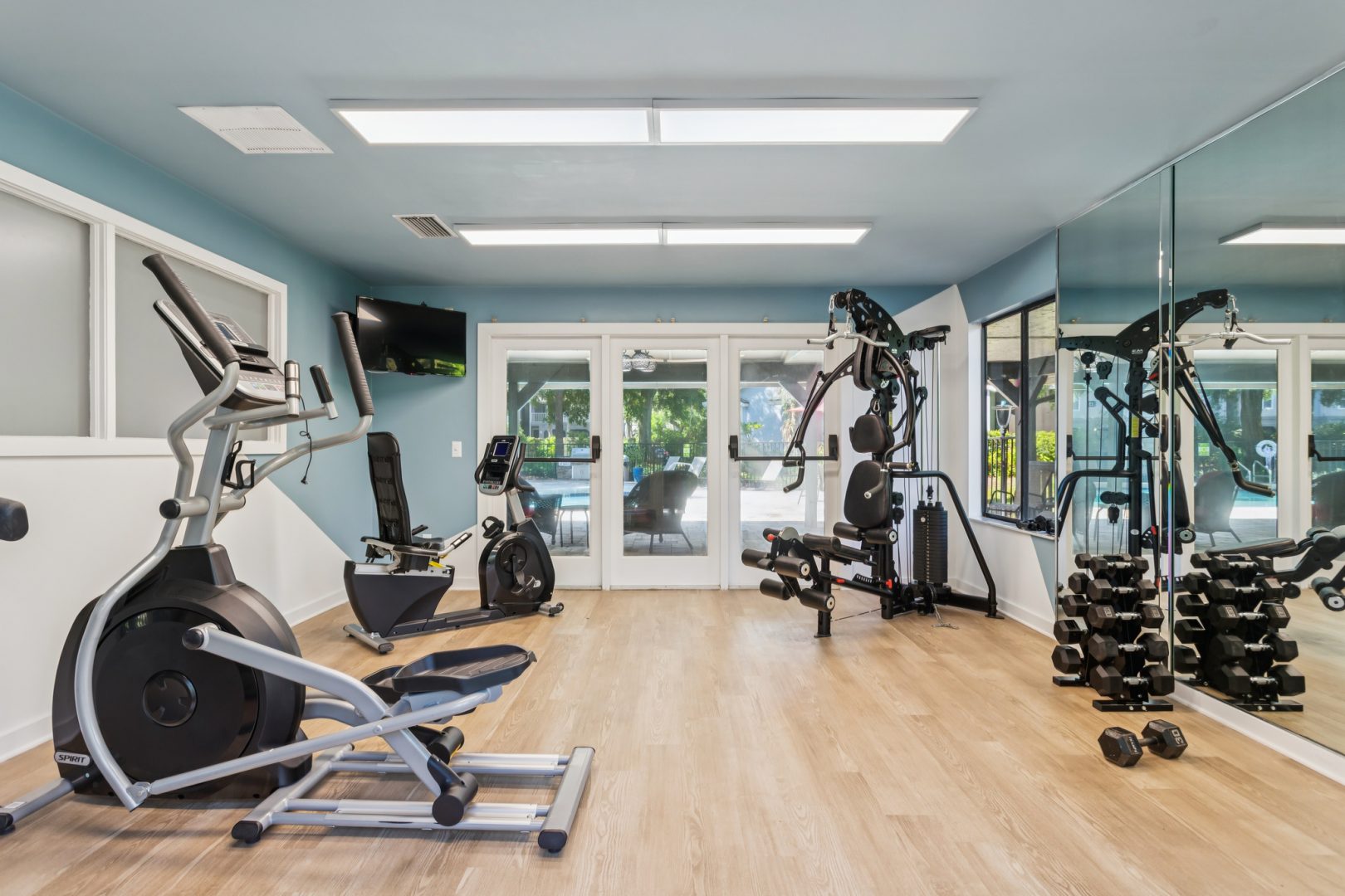 a gym room with exercise equipment and mirrors at The Vista Bay